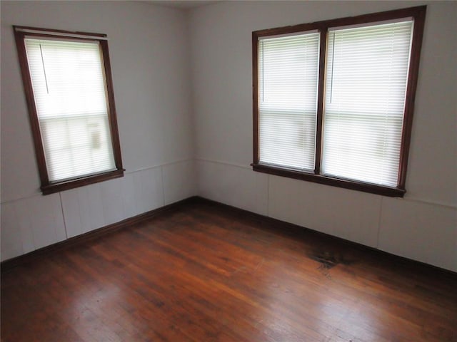 608 W Walnut St, Tecumseh, OK 74873 - spare room featuring dark wood-style flooring and plenty of natural light