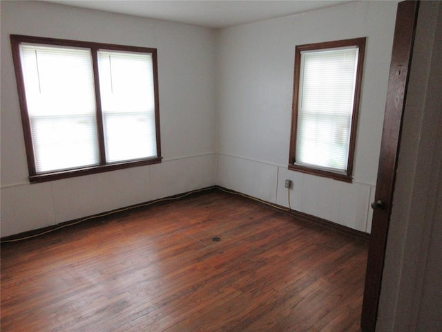 608 W Walnut St, Tecumseh, OK 74873 - empty room with plenty of natural light and dark wood-type flooring