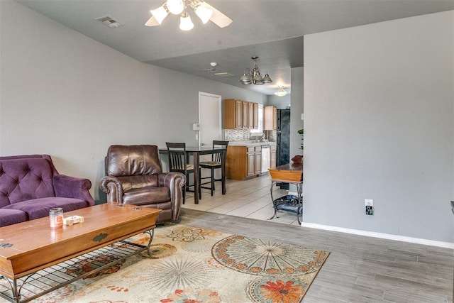 1705 NW 147th St, Edmond, OK 73013 - living area featuring ceiling fan, light wood-style flooring, and baseboards