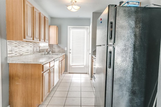 1705 NW 147th St, Edmond, OK 73013 - kitchen featuring freestanding refrigerator, a sink, light tile patterned floors, light countertops, and decorative backsplash