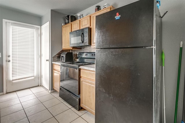 1705 NW 147th St, Edmond, OK 73013 - kitchen featuring black appliances, light brown cabinets, light tile patterned floors, and light countertops