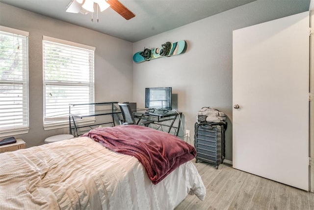 1705 NW 147th St, Edmond, OK 73013 - bedroom with light wood finished floors and ceiling fan