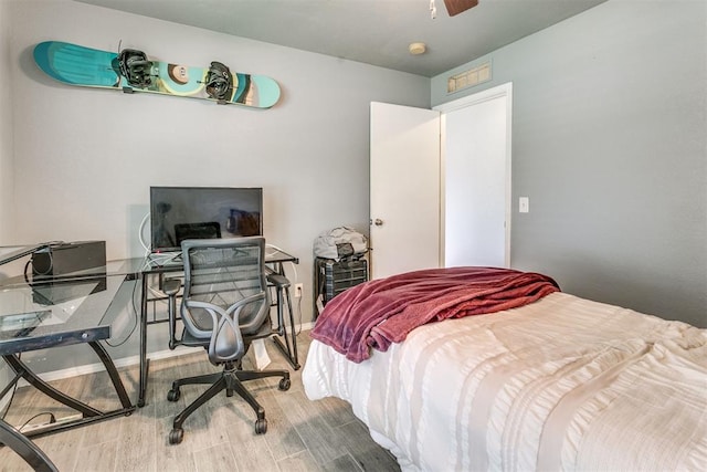 1705 NW 147th St, Edmond, OK 73013 - bedroom featuring wood finished floors, a desk, ceiling fan, and baseboards