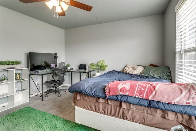 1705 NW 147th St, Edmond, OK 73013 - bedroom with wood finished floors, an office area, and a ceiling fan
