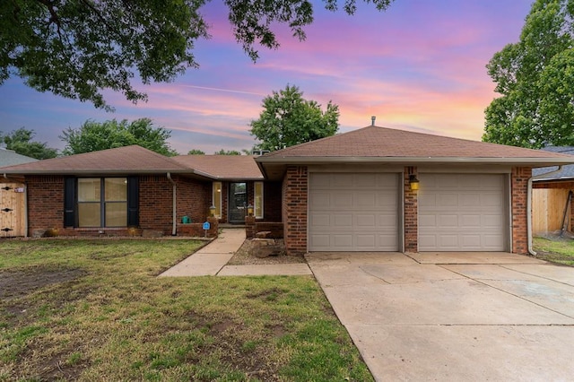 2232 Butternut Pl, Edmond, OK 73013 - ranch-style house featuring brick siding, a front lawn, concrete driveway, and an attached garage