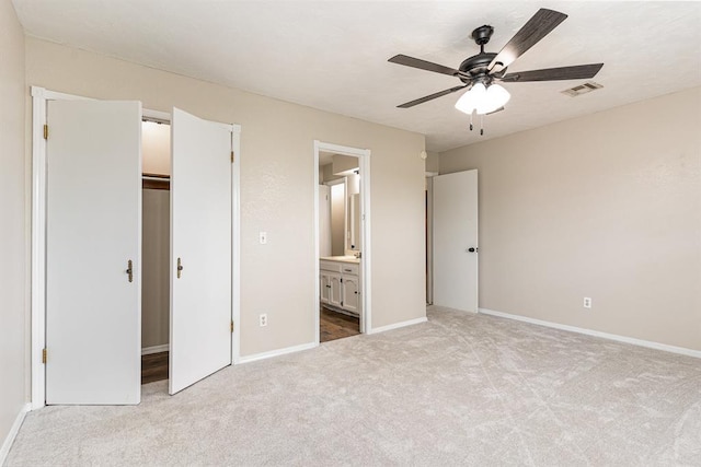 2232 Butternut Pl, Edmond, OK 73013 - unfurnished bedroom featuring light colored carpet, baseboards, ensuite bath, and a ceiling fan