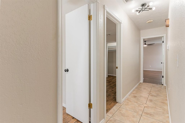 2232 Butternut Pl, Edmond, OK 73013 - hallway featuring light tile patterned flooring and baseboards