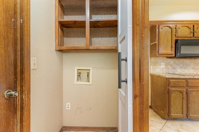 2232 Butternut Pl, Edmond, OK 73013 - washroom with washer hookup and light tile patterned floors