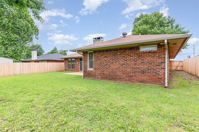 2232 Butternut Pl, Edmond, OK 73013 - rear view of house featuring brick siding and a chimney