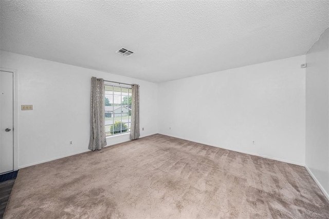 7506 NW Welco Ave, Lawton, OK 73505 - spare room with carpet flooring, a textured ceiling, and baseboards