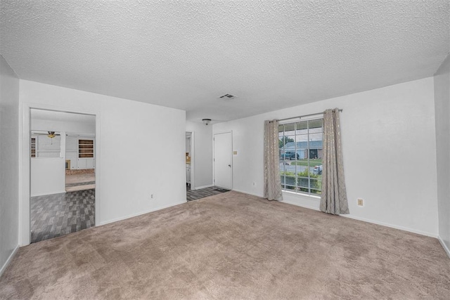 7506 NW Welco Ave, Lawton, OK 73505 - unfurnished living room with carpet, a textured ceiling, a ceiling fan, and baseboards