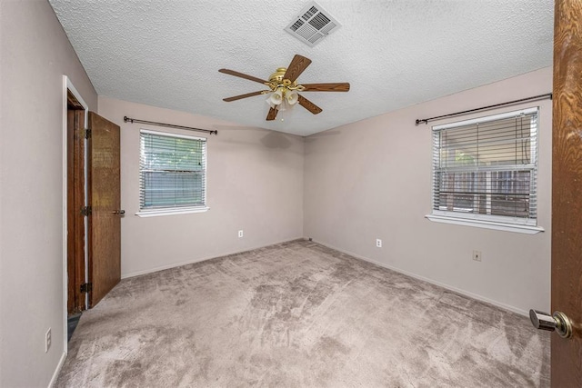 7506 NW Welco Ave, Lawton, OK 73505 - spare room with ceiling fan, carpet floors, a textured ceiling, and baseboards
