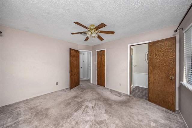 7506 NW Welco Ave, Lawton, OK 73505 - unfurnished bedroom with carpet flooring, ceiling fan, ensuite bath, and a textured ceiling