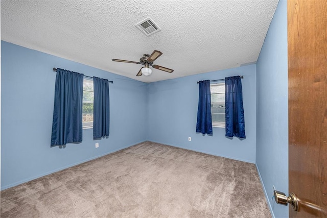 7506 NW Welco Ave, Lawton, OK 73505 - carpeted empty room with a ceiling fan, baseboards, and a textured ceiling