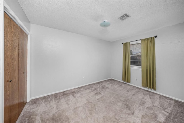 7506 NW Welco Ave, Lawton, OK 73505 - carpeted empty room with a textured ceiling and baseboards