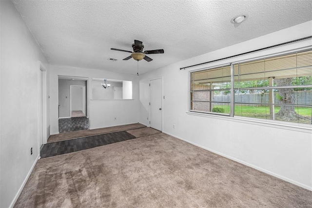 7506 NW Welco Ave, Lawton, OK 73505 - unfurnished living room featuring a textured ceiling, carpet, a ceiling fan, and baseboards