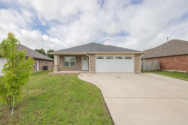 6100 SE 7th St, Midwest City, OK 73110 - view of front of house featuring a garage, central AC, concrete driveway, brick siding, and roof with shingles