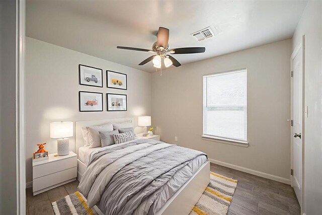 6100 SE 7th St, Midwest City, OK 73110 - bedroom featuring baseboards, wood finished floors, and a ceiling fan