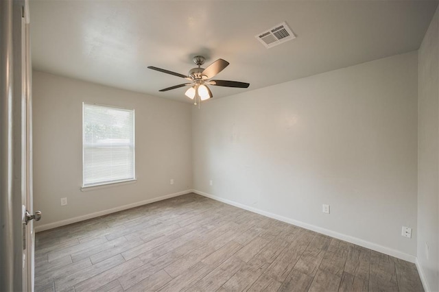 6100 SE 7th St, Midwest City, OK 73110 - spare room featuring ceiling fan, wood finished floors, and baseboards