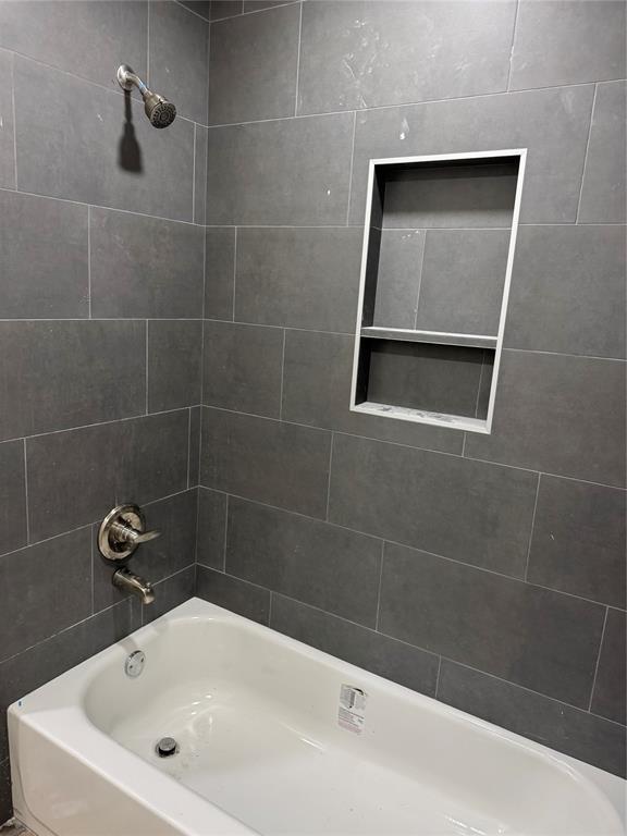106 Briarwood Crossroads, Moore, OK 73160 - bathroom featuring washtub / shower combination