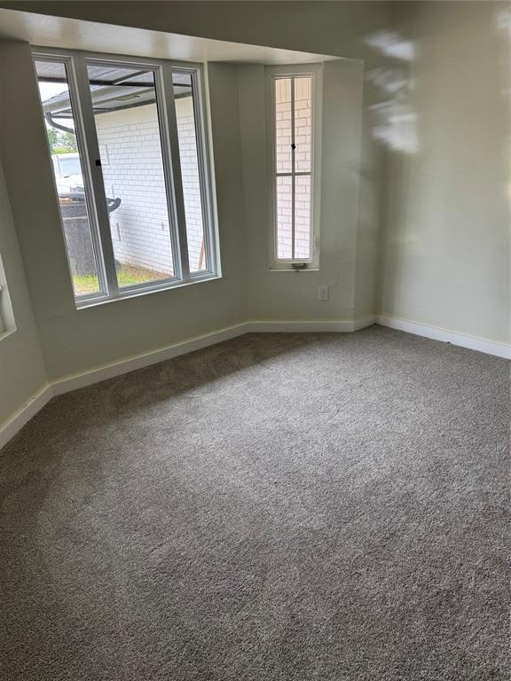 106 Briarwood Crossroads, Moore, OK 73160 - spare room featuring baseboards and carpet flooring