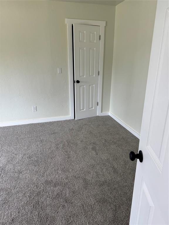 106 Briarwood Crossroads, Moore, OK 73160 - empty room with carpet flooring and baseboards