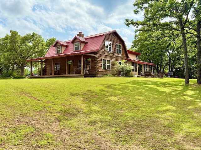 10813 S Peggy Lou Dr, Oklahoma City, OK 73165 - rear view of house with log exterior, metal roof, a chimney, covered porch, and a yard