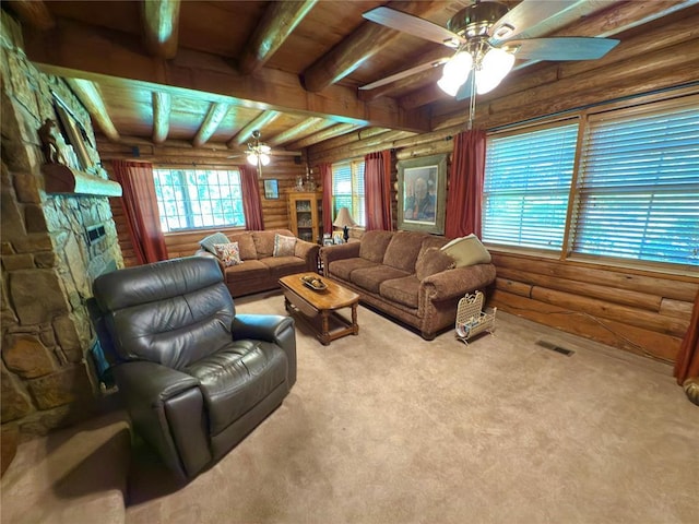 10813 S Peggy Lou Dr, Oklahoma City, OK 73165 - carpeted living area with a ceiling fan, log walls, beamed ceiling, and a stone fireplace