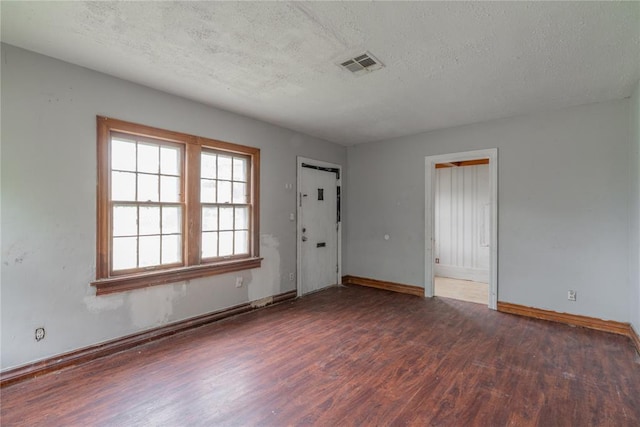 2325 E Madison St, Oklahoma City, OK 73111 - empty room featuring wood finished floors and a textured ceiling
