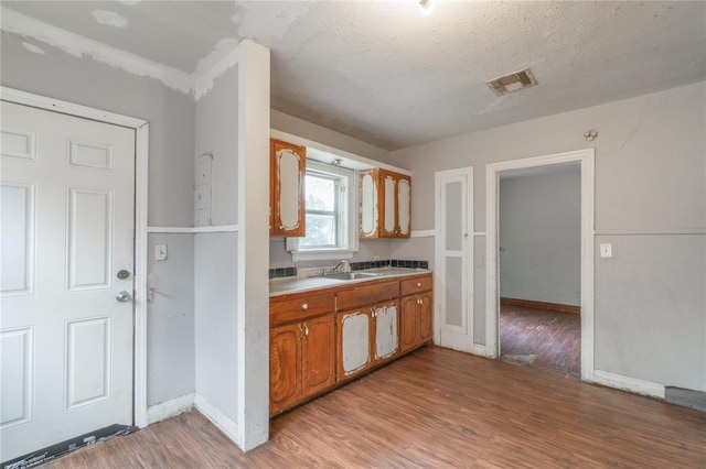 2325 E Madison St, Oklahoma City, OK 73111 - kitchen with light wood finished floors and brown cabinets
