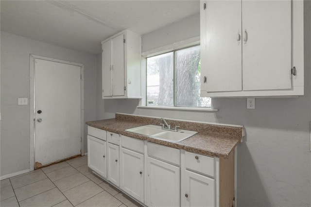2325 E Madison St, Oklahoma City, OK 73111 - kitchen featuring white cabinets and light tile patterned flooring