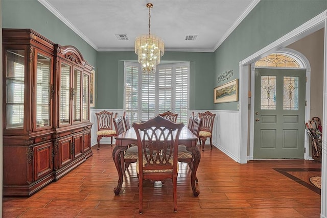 409 Pheasant Cir, Altus, OK 73521 - dining area with a chandelier, wood finished floors, wainscoting, and crown molding