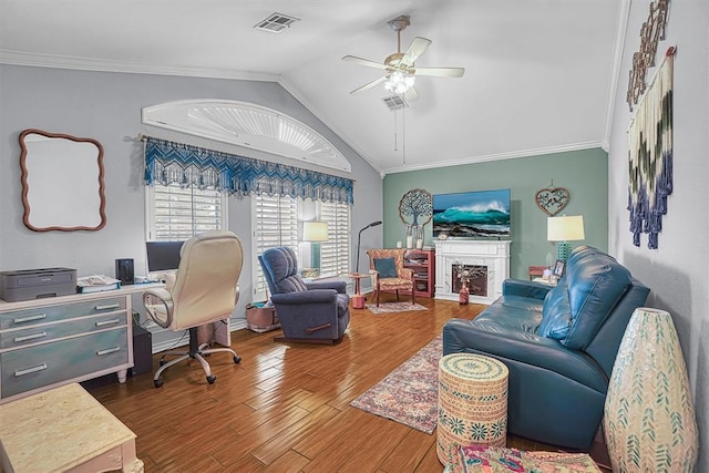 409 Pheasant Cir, Altus, OK 73521 - office featuring a ceiling fan, lofted ceiling, wood finished floors, ornamental molding, and a fireplace