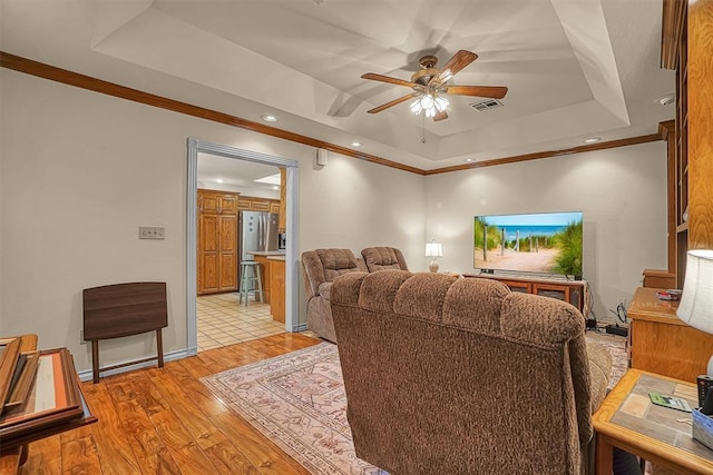 409 Pheasant Cir, Altus, OK 73521 - living area with a raised ceiling, light wood-style floors, crown molding, ceiling fan, and recessed lighting