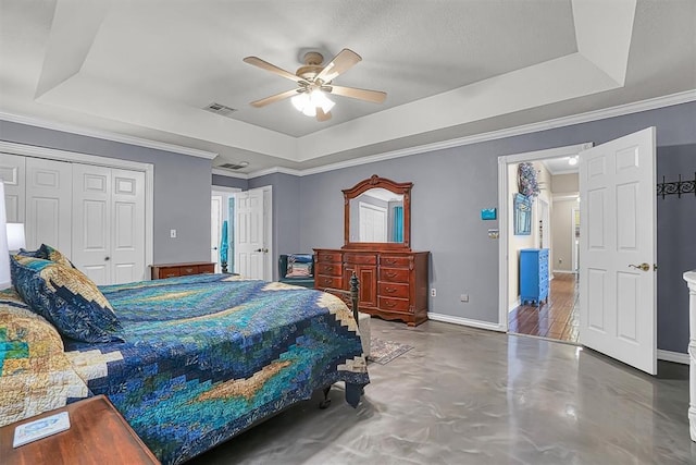 409 Pheasant Cir, Altus, OK 73521 - bedroom with a tray ceiling, concrete floors, a ceiling fan, a closet, and ornamental molding