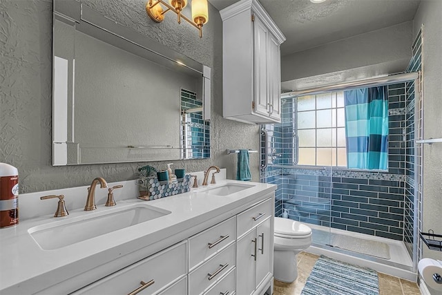 409 Pheasant Cir, Altus, OK 73521 - bathroom with a textured wall, a shower stall, and double vanity