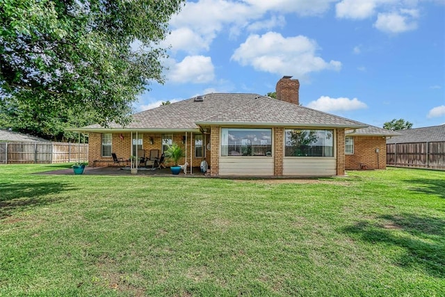 409 Pheasant Cir, Altus, OK 73521 - back of house with a patio, a chimney, brick siding, and a fenced backyard