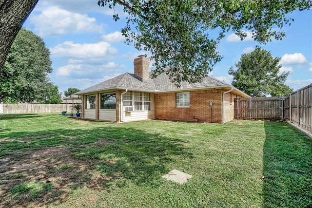 409 Pheasant Cir, Altus, OK 73521 - back of property featuring brick siding, a chimney, a fenced backyard, a shingled roof, and cooling unit