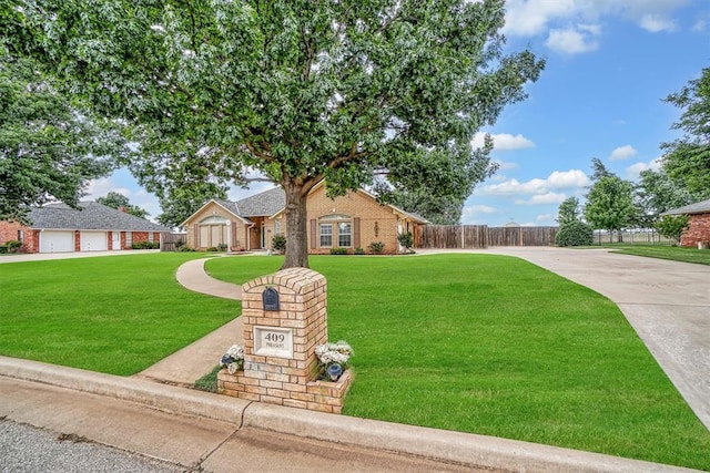 409 Pheasant Cir, Altus, OK 73521 - view of front facade featuring brick siding and driveway