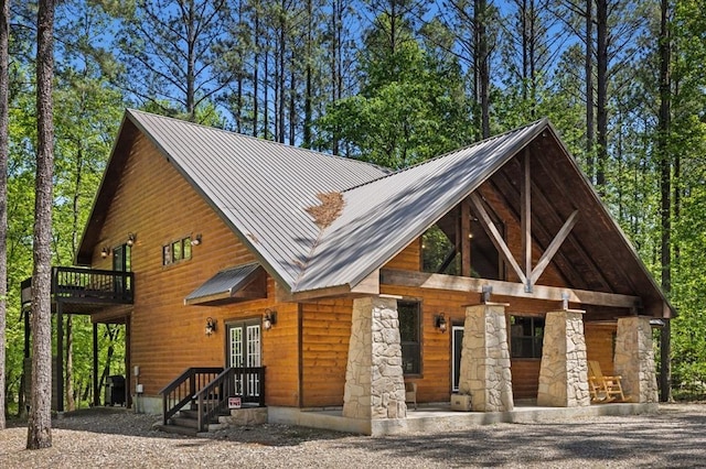 372 Timber Creek Trl, Broken Bow, OK 74728 - view of front of property with stone siding, metal roof, and french doors