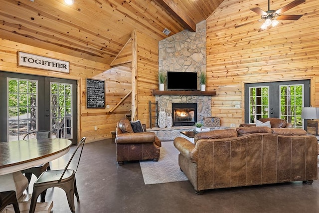 372 Timber Creek Trl, Broken Bow, OK 74728 - living area featuring french doors, concrete floors, high vaulted ceiling, plenty of natural light, and wooden walls