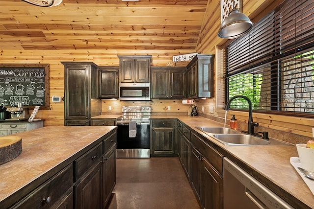 372 Timber Creek Trl, Broken Bow, OK 74728 - kitchen with stainless steel appliances, a sink, wooden walls, concrete flooring, and dark brown cabinets