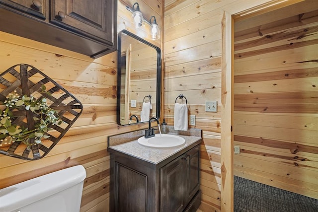 372 Timber Creek Trl, Broken Bow, OK 74728 - bathroom featuring wooden walls, toilet, and vanity