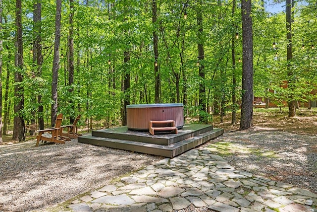 372 Timber Creek Trl, Broken Bow, OK 74728 - view of property's community with a hot tub, a patio, and a wooden deck