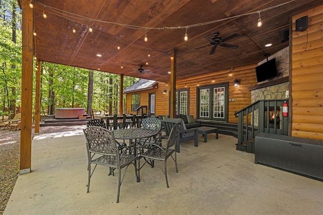 372 Timber Creek Trl, Broken Bow, OK 74728 - view of patio / terrace with a hot tub, ceiling fan, an outdoor hangout area, and outdoor dining space