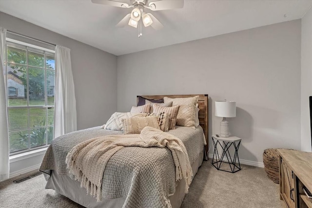 1401 Cedar Ridge Rd, Edmond, OK 73013 - bedroom with light carpet, baseboards, and ceiling fan