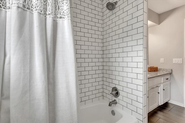 1401 Cedar Ridge Rd, Edmond, OK 73013 - bathroom featuring shower / bath combo with shower curtain, vanity, baseboards, and wood finished floors