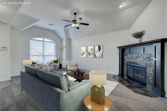4116 NW 155th St, Edmond, OK 73013 - carpeted living area featuring vaulted ceiling, ceiling fan, a stone fireplace, and baseboards