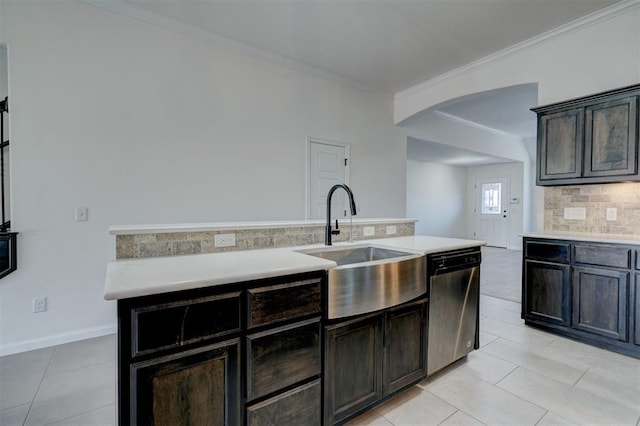 4116 NW 155th St, Edmond, OK 73013 - kitchen featuring dishwasher, arched walkways, a sink, ornamental molding, and light countertops