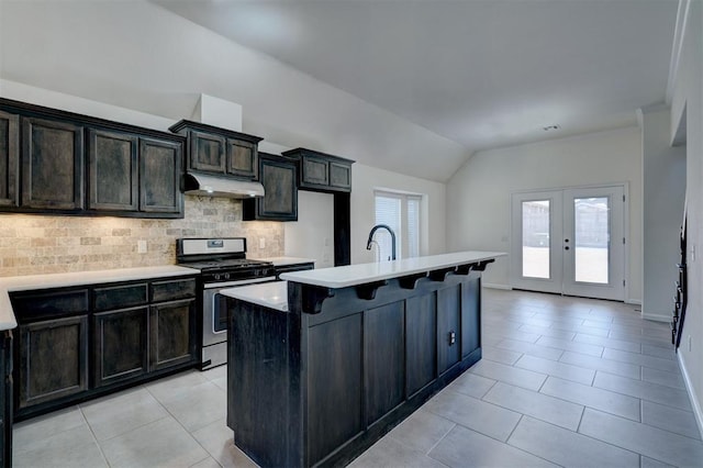 4116 NW 155th St, Edmond, OK 73013 - kitchen featuring gas stove, light tile patterned floors, lofted ceiling, decorative backsplash, and french doors